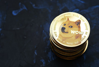 Pile of golden dogecoin cryptocurrencies on dark textured background
